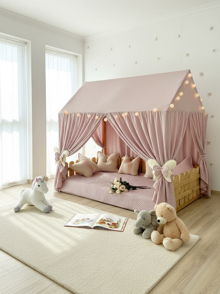 Kids’ bedroom with handmade pink muslin canopy over Montessori bed, cozy reading nook decor.
