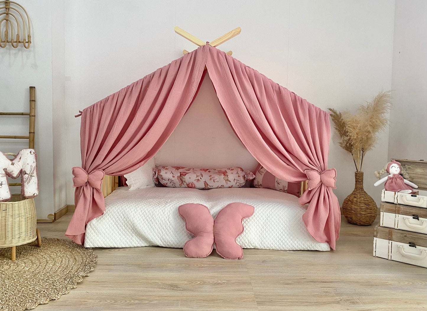Blush pink canopy over Montessori floor bed